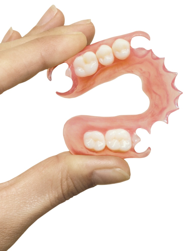 hand holding dentures